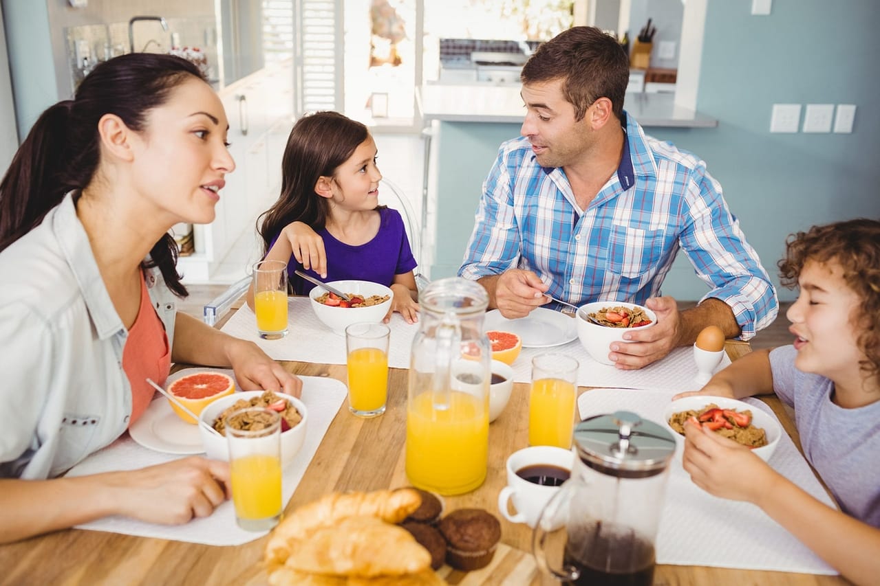 happy family talking while having breakfast