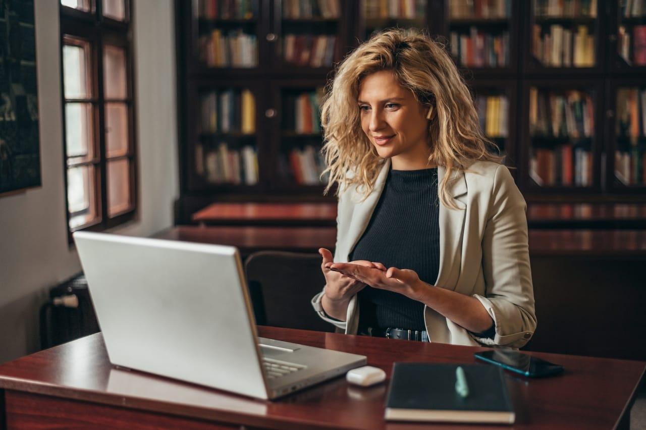 businesswoman using a laptop for an online meeting while in the